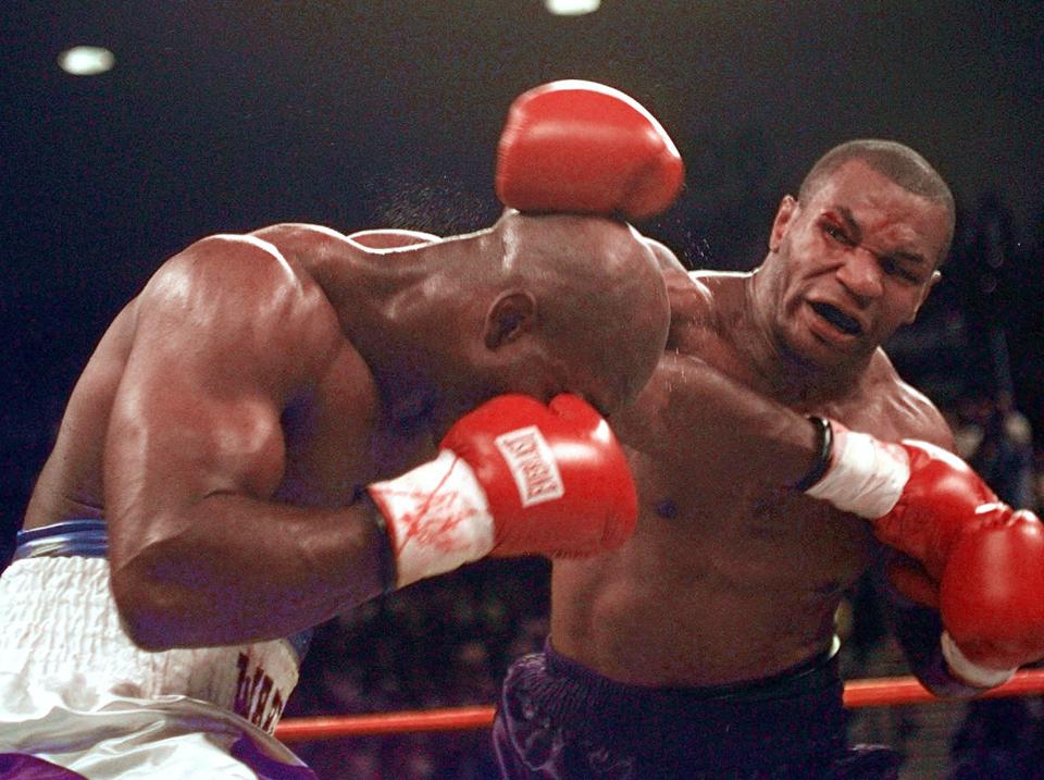 <p>Mike Tyson and Evander Holyfield exchange punches during their WBA Heavyweight match Saturday, June 28, 1997, at the MGM Grand in Las Vegas. The fight was stopped after Tyson bit Holyfield on each ear during the third round. Tyson was disqualified and Holyfield retained his title. (AP Photo/Lenny Ignelzi) </p>