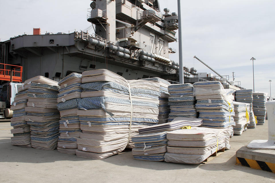 In this Oct. 15, 2012 photo provided by the U.S. Navy,mattresses from the USS Abraham Lincoln to be recycled await transport on Pier 11 Naval Station in Norfolk, Va. The mattresses from two Virginia-based aircraft carriers and an amphibious transport dock are having their parts recycled by a South Carolina company this year for other uses. In all, the Navy plans to recycle 13,000 mattresses from the USS Enterprise, USS Abraham Lincoln and USS Mesa Verde as part of a pilot program run by Naval Facilities Engineering Command Mid-Atlantic's Integrated Solid Waste. (AP Photo/U.S. Navy, John Land) Recycling