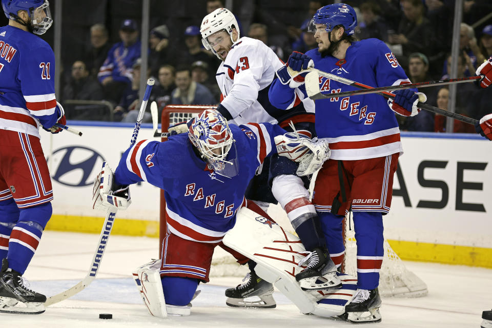 New York Rangers goaltender Igor Shesterkin pushes Washington Capitals right wing Tom Wilson (43) against Rangers defenseman Ryan Lindgren during the second period of an NHL hockey game Wednesday, Dec. 27, 2023, in New York. (AP Photo/Adam Hunger)