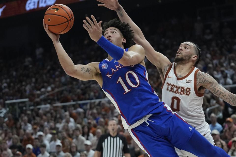 Kansas forward Jalen Wilson shoots in front of Texas forward Timmy Allen.