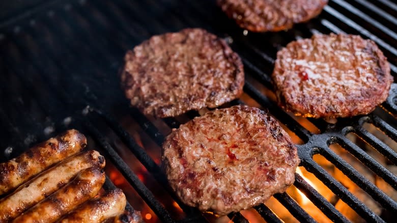 Burgers on grill over flame