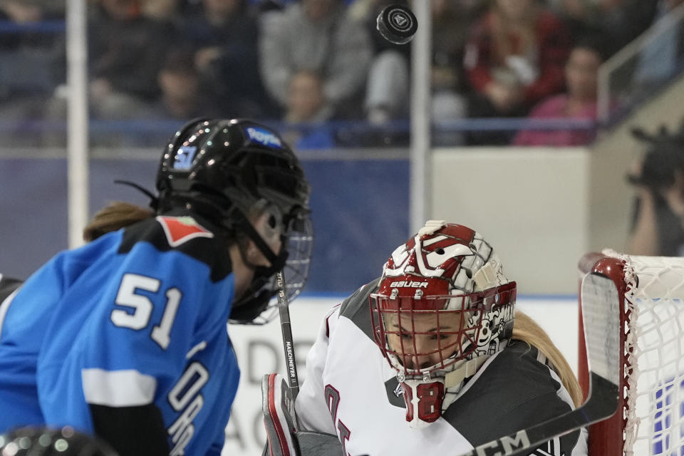 Ottawa goalie Emerance Maschmeyer, right, and Toronto's Victoria Bach (51) lose sight of the puck during second-period PWHL hockey game action in Toronto, Sunday, May 5, 2024. (Frank Gunn/The Canadian Press via AP)
