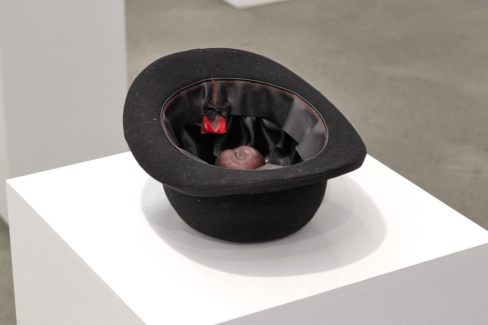There is an actual “single plum, floating in perfume, served in a mans hat” on display right now.