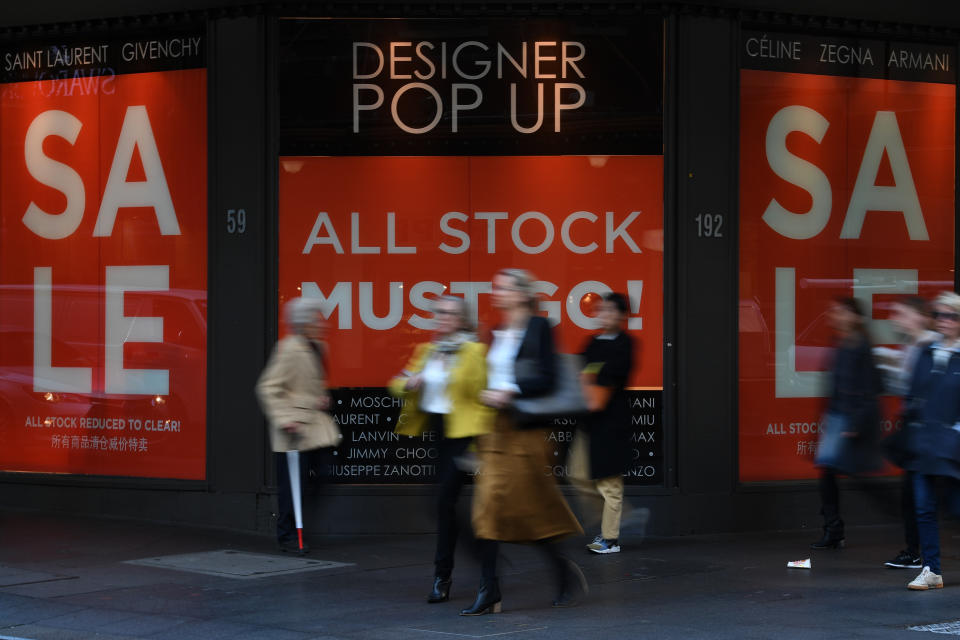 Shoppers walk past retails outlets David Jones and Myer in Sydney, Monday, June 4, 2018.  (AAP Image/Dean Lewins) 