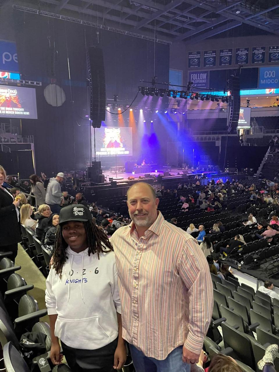 Braxton Schafer and his father Derrick Schafer attend the Snoop Dogg concert at the PREMIER Center on April 19, 2022. Braxton wore a Snoop Dogg hat and an O'Gorman Class of 2026 sweatshirt to the event.