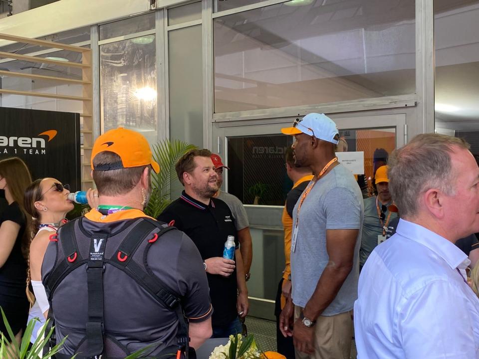 TV personality James Corden (left) and former NFL player Michael Strahan chat in McLaren F1 hospitality at the Miami Grand Prix.