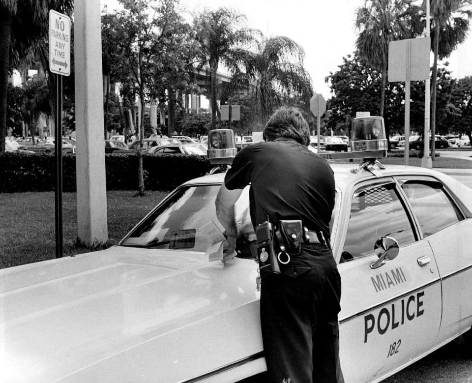 An officer at a Miami police car in 1977.