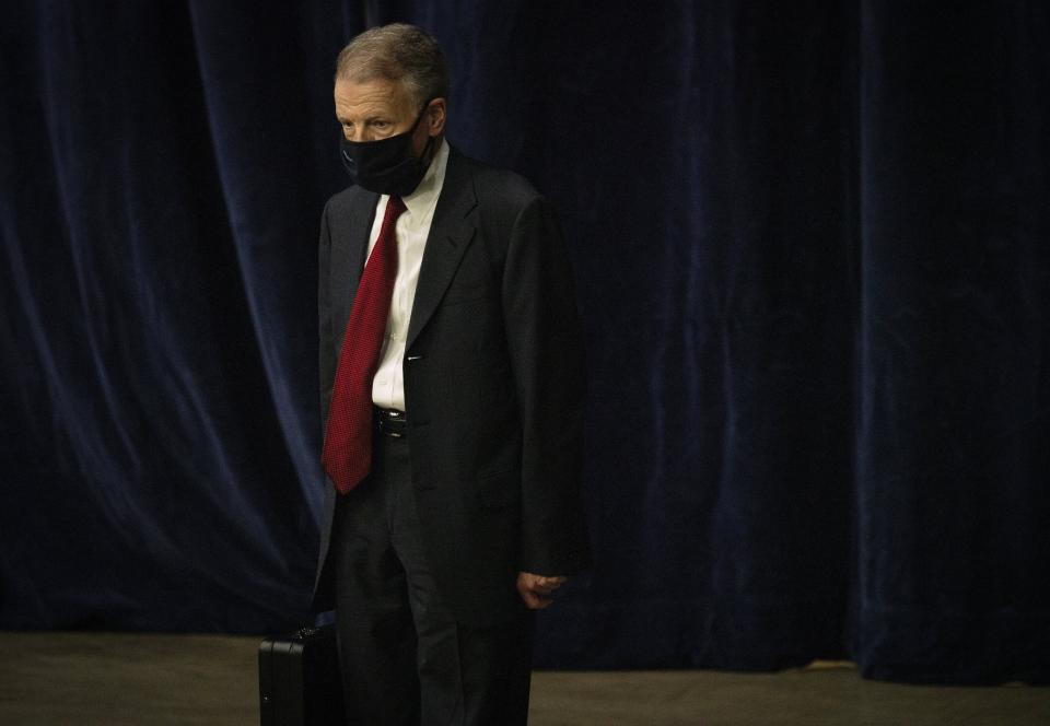 FILE - In this Jan. 8, 2021, file photo, Illinois House Speaker Michael Madigan walks on the floor as the Illinois House of Representatives convenes at the Bank of Springfield Center, in Springfield, Ill. Speaker Madigan on Monday, Jan. 11, 2021, said he was “suspending” his campaign for a 19th term in the leadership post. Madigan, the longest-serving leader of a legislative body in U.S. history, issued a statement that began, “This is not a withdrawal.” But it urged House Democrats to “work to find someone, other than me, to get 60 votes for speaker.” (E. Jason Wambsgans/Chicago Tribune via AP File)