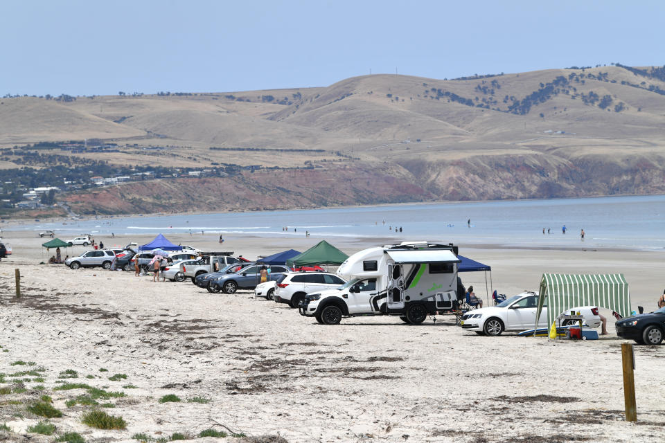 Cars are seen parked at Aldinga Beach in Adelaide on Tuesday. A heatwave spreading across Australia is expected to see parts of the nation swelter. Source: AAP Image/David Mariuz