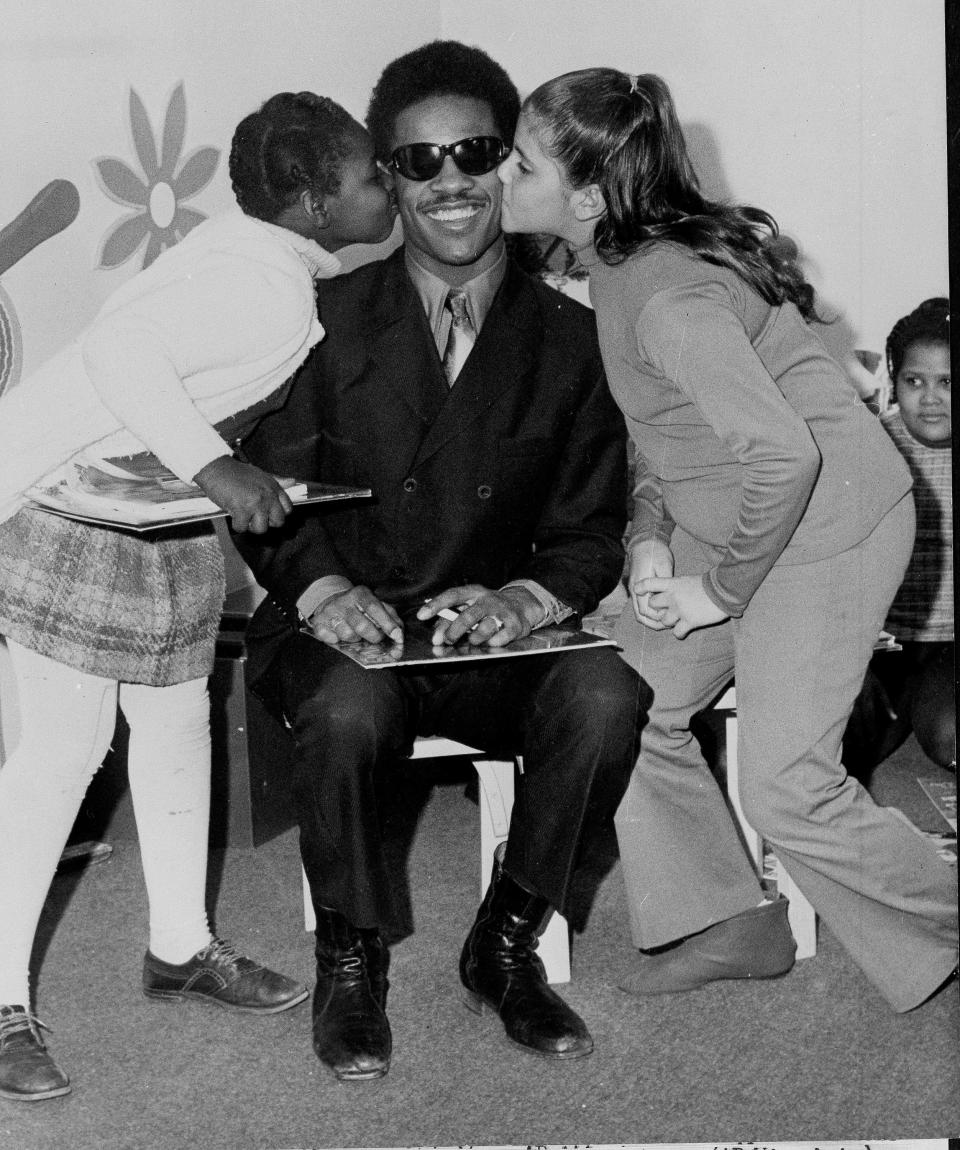 Stevie Wonder, shown in 1970 at the Eye Institute of the Columbia Presbyterian Medical Center in New York giving out his albums to young patients.