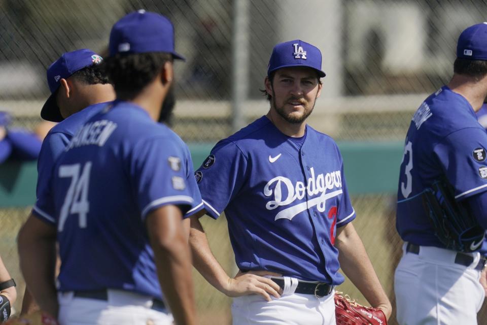 Los Angeles Dodgers starting pitcher Trevor Bauer, right, talks with Dodgers relief pitcher Kenley Jansen (74) during a spring training baseball practice Tuesday, Feb. 23, 2021, in Phoenix. (AP Photo/Ross D. Franklin)