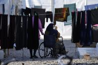 Migrants gather outside their tents before the visit of Pope Francis at the Karatepe refugee camp, on the northeastern Aegean island of Lesbos, Greece, Sunday, Dec. 5, 2021. Pope Francis is returning to Lesbos, the Greek island that was at the heart of a massive wave of migration into Europe six years ago, after making pointed criticism of European governments on the handling of the crisis during a visit to two hard-hit countries. (AP Photo/Alessandra Tarantino)