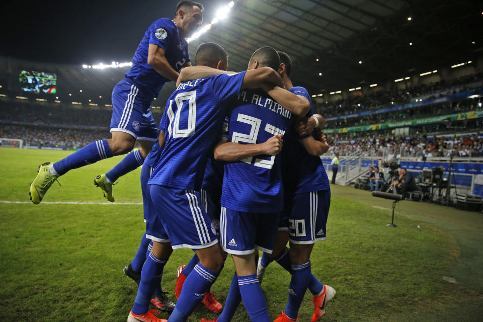 Paraguay's players celebrate with Richard Sanchez after scoring against Argentina during a Copa America Group B soccer match at the Mineirao stadium in Belo Horizonte, Brazil, Wednesday, June 19, 2019. (AP Photo/Natacha Pisarenko)