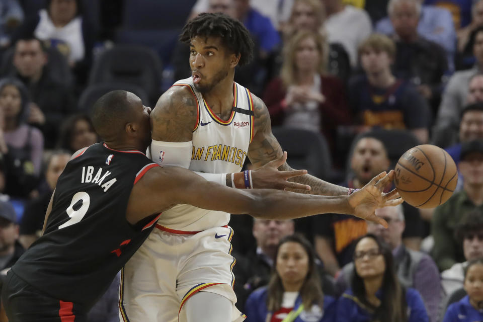 Toronto Raptors center Serge Ibaka (9) knocks the ball away from Golden State Warriors forward Marquese Chriss during the first half of an NBA basketball game in San Francisco, Thursday, March 5, 2020. (AP Photo/Jeff Chiu)