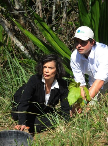 Bianca Jagger (L) plants a King tree beside Terra Institute of Environmental Preservation (IPTA) environmentalist Mauricio Ruiz in the framework of the Rio +20 Environmental Summit. The UN conference, which marks the 20th anniversary of the Earth Summit -- a landmark 1992 gathering that opened the debate on the future of the planet and its resources -- is the largest ever organized