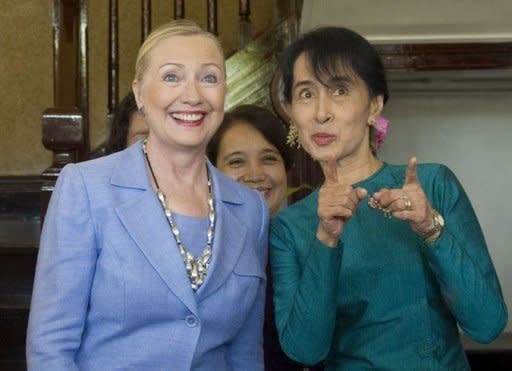 Pro-democracy opposition leader Aung San Suu Kyi and US Secretary of State Hillary Clinton talk prior to meetings at Suu Kyi's residence in Yangon on December 2, 2011. Clinton greeted the Nobel Peace Prize laureate and kissed her on both cheeks as the top US diplomat arrived at the crumbling lakeside mansion in Yangon where Suu Kyi spent most of the past two decades as a prisoner in her own home