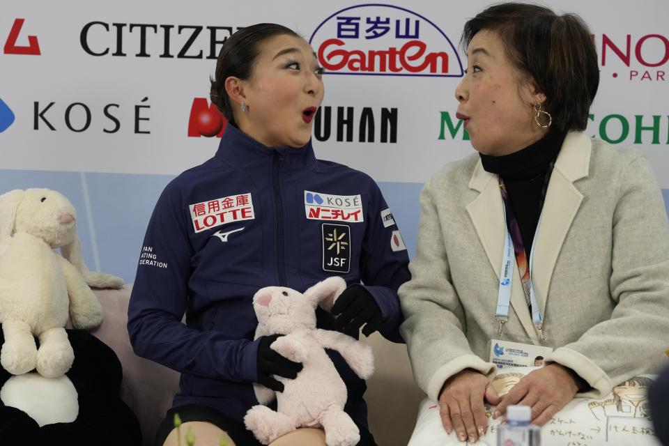Japan's Kaori Sakamoto and her coach react to her Free Skating routine score on her way to the gold medal in the Women's Final for the ISU Grand Prix of Figure Skating Final held in Beijing, Saturday, Dec. 9, 2023. (AP Photo/Ng Han Guan)