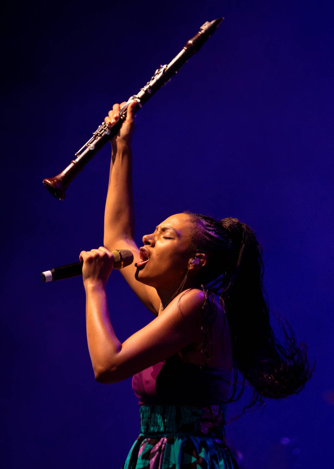 Allison Russell lifts her clarinet into the air as she performs opening for Hozier in concert at Coastal Credit Union Music Park at Walnut Creek in Raleigh, N.C., Saturday night, April 20, 2024.