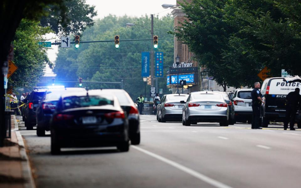 Cars and police gather around Altria Theater, the site of a shooting at the Huguenot High School graduation - Richmond Times-Dispatch