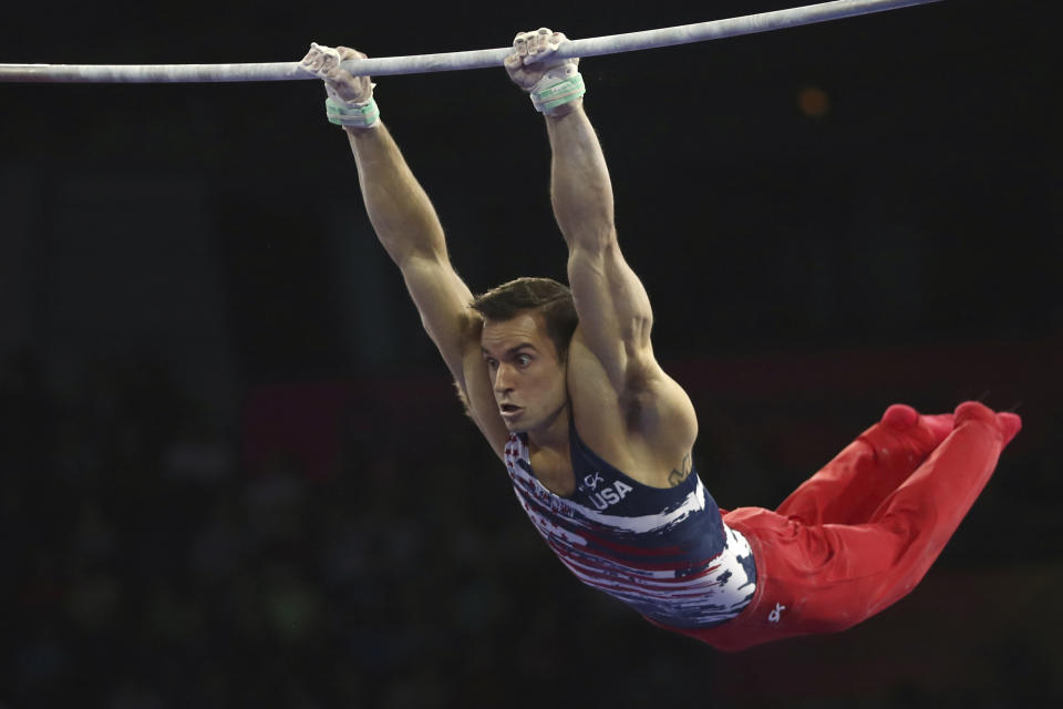 Samuel Mikulak of the United States performs on the horizontal bar in the men's all-around final at the Gymnastics World Championships in Stuttgart, Germany, Friday, Oct. 11, 2019. (AP Photo/Matthias Schrader)