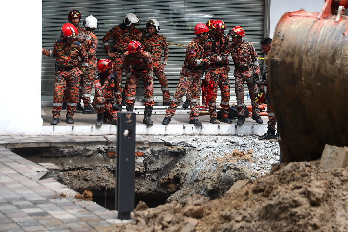 Rescue operation after woman falls into 8m-deep sinkhole in Kuala Lumpur (EPA)