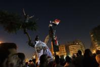 Egyptian anti-Mubarak protesters hold their national flags during a demonstration in Cairo's Tahrir square. Thousands of angry protesters across Egypt took to the streets on Saturday after Mubarak and his security chief were given life in prison over the deaths of protesters in 2011 but six police chiefs were acquitted