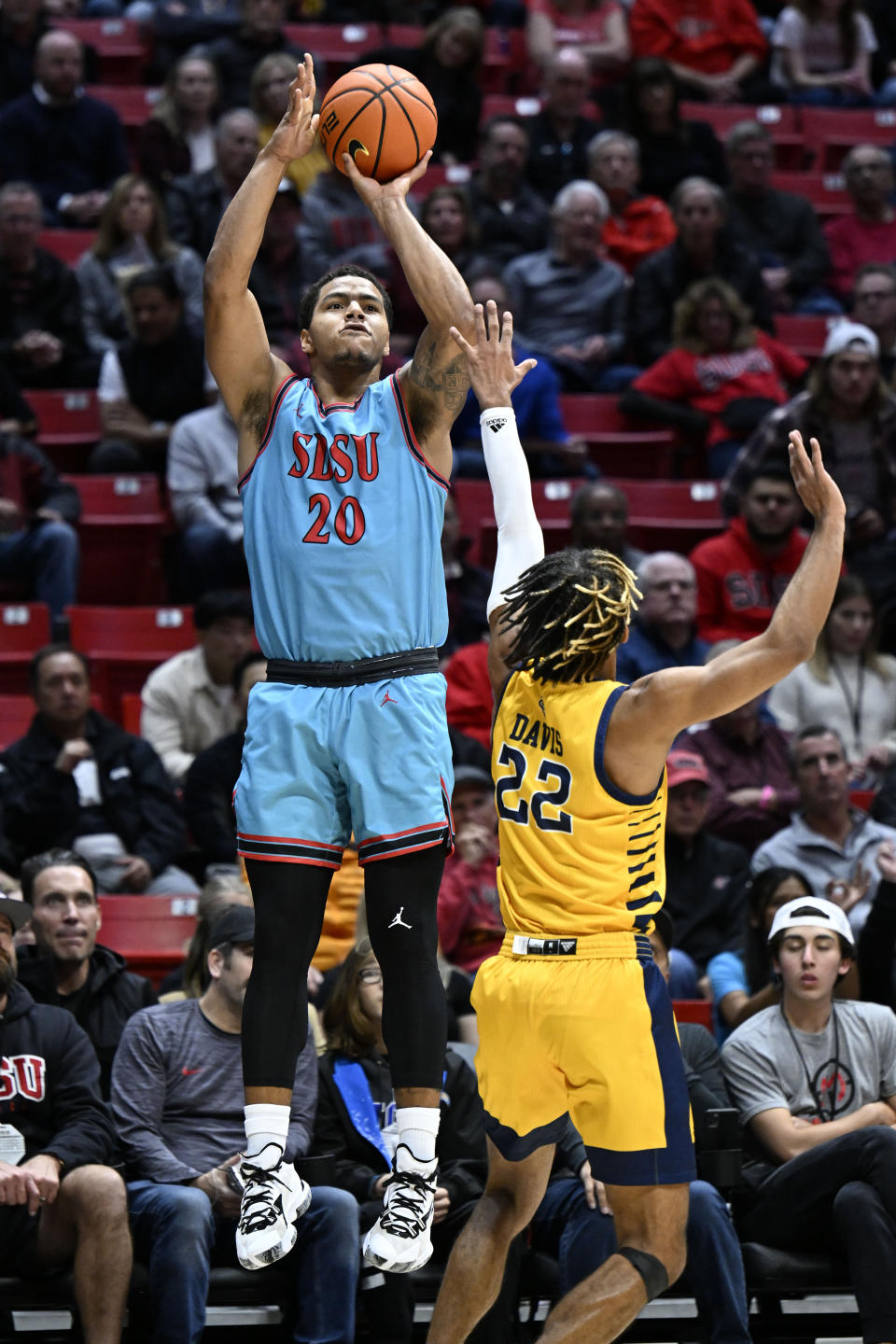 San Diego State guard Matt Bradley (20) shoots over UC Irvine guard DJ Davis (22) during the first half of an NCAA college basketball game Tuesday, Nov. 29, 2022, in San Diego. (AP Photo/Denis Poroy)