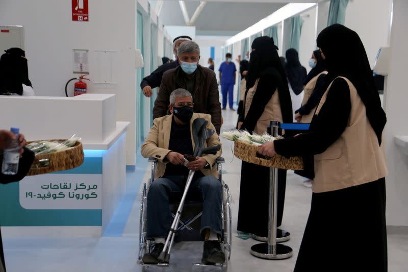 A man in a wheelchair leaving after he received dose of a coronavirus disease (COVID-19) vaccine, in Riyadh