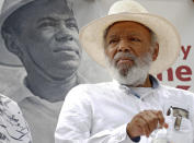 FILE- In this June 26, 2016, photo, civil rights activist James Meredith sits in front of a 1966 photograph of himself during a commemoration of the 50th anniversary of his 1966 March Against Fear at the Capitol in Jackson, Miss. "Walk Against Fear: James Meredith," scheduled to air Thursday, Oct. 1, 2020, on the Smithsonian Channel, examines the life of a U.S. Air Force veteran-turn-human right agitator whose admission into the University of Mississippi forced President John F. Kennedy to send federal troops into the state to quell a white supremacy uprising. It was one of the most violent moments of the Civil Rights Movement and it forever changed life in the American Deep South. (AP Photo/Rogelio V. Solis, File)