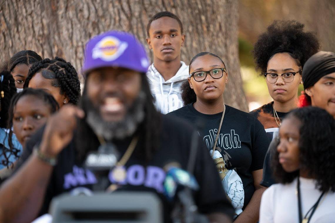 Youth from Sacramento stand behind community activist Berry Accius during the Organized Voices and Voices of Youth rally at the state Capitol on Thursday.