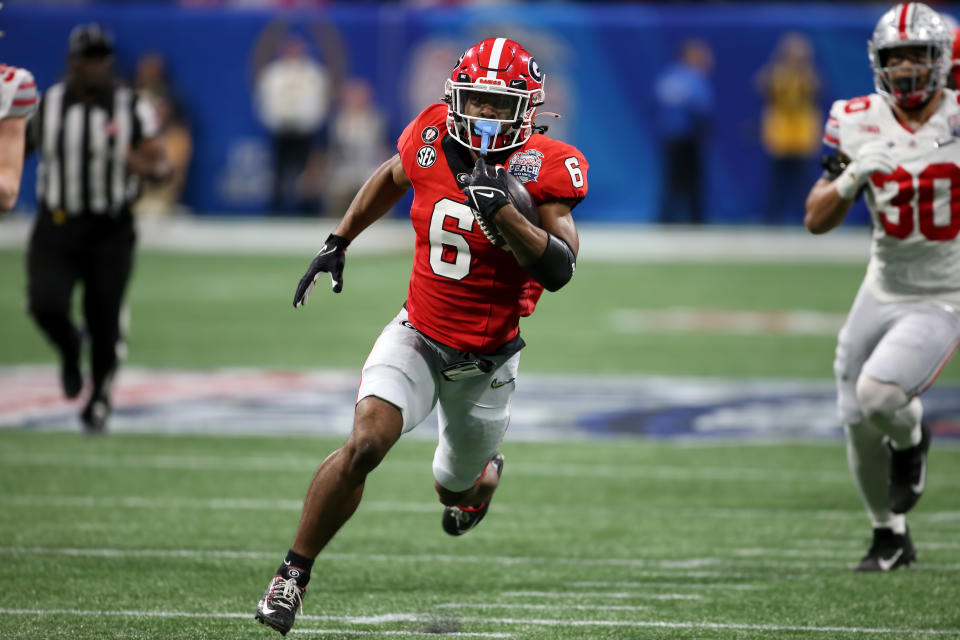 ATLANTA, GA - DECEMBER 31: Georgia Bulldogs running back Kenny McIntosh (6) carries the ball during the college football Playoff Semifinal game at the Chick-fil-a Peach Bowl between the Georgia Bulldogs and the Ohio State Buckeyes on December 31, 2022 at Mercedes-Benz Stadium in Atlanta, Georgia.  (Photo by Michael Wade/Icon Sportswire via Getty Images)