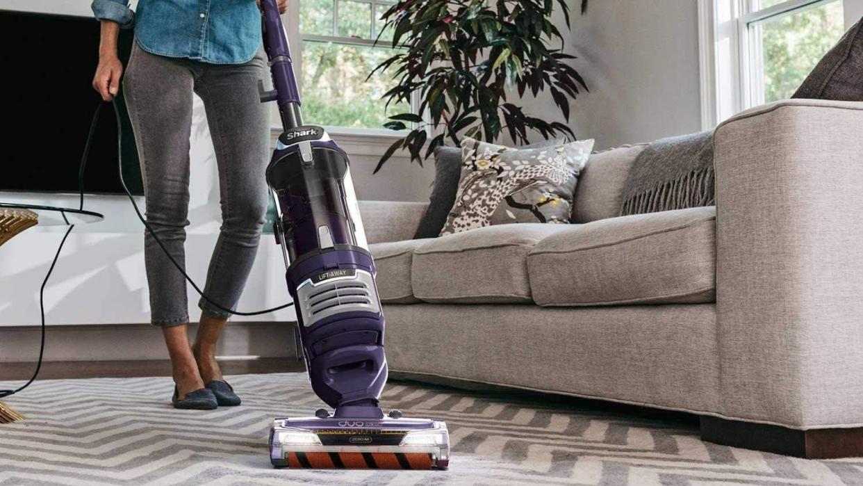  A Shark Rotator Pet Lift-Away Upright Vacuum on a carpet. 