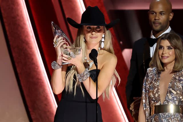 <p>Terry Wyatt/Getty</p> Lainey Wilson wins album of the year at the CMA Awards