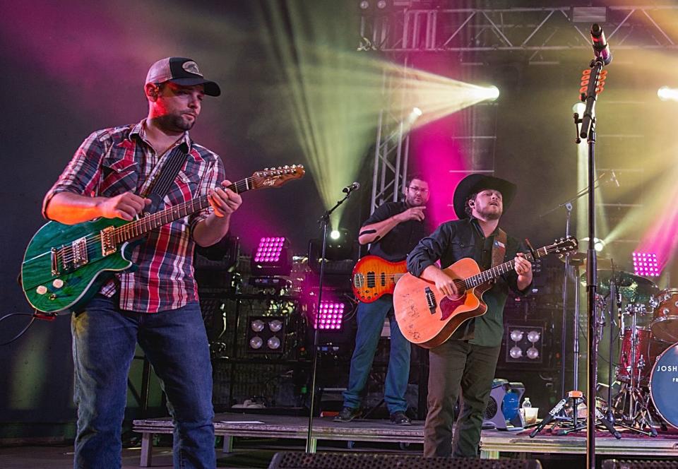 Caleb Keeter, left, performs with the Josh Abbott Band in 2016. (Photo: Rick Kern via Getty Images)