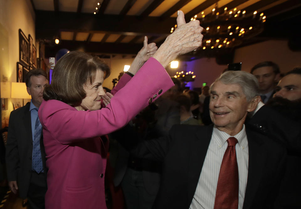 U.S. Sen. Dianne Feinstein, left, gestures toward supporters before speaking at an election night event in San Francisco, Tuesday, Nov. 6, 2018. (AP Photo/Jeff Chiu)