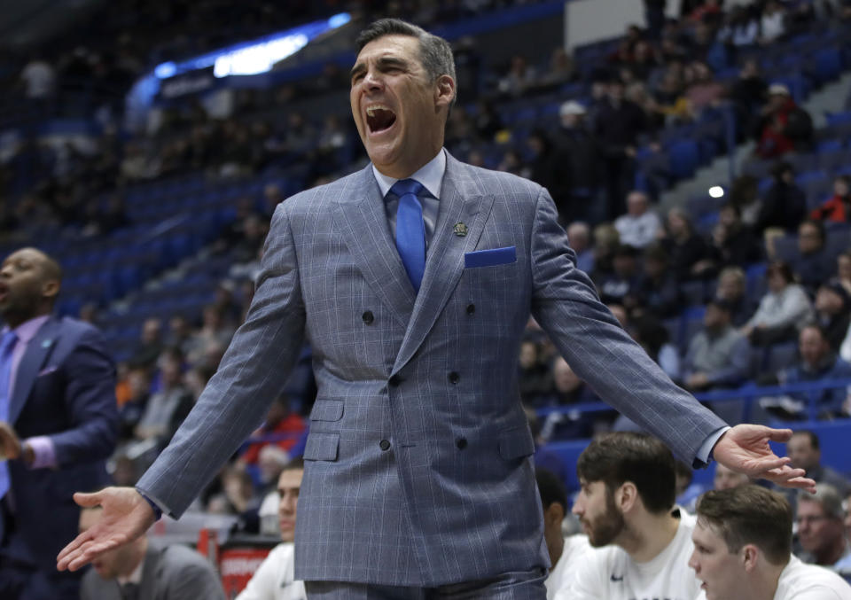 FILE - In this March 21, 2019, file photo, Villanova head coach Jay Wright reacts from the bench during the first half of a first round men's college basketball game against St. Mary's in the NCAA Tournament in Hartford, Conn. Villanova students are headed back to school this week _ while the Villanova men's basketball coach will be halfway around the world for the next month or so. It has been, and will continue being, a major schedule challenge for Wright as he's tasked with both helping USA Basketball win a gold medal while his college players are on campus getting ready to start their seasons.(AP Photo/Elise Amendola, File)