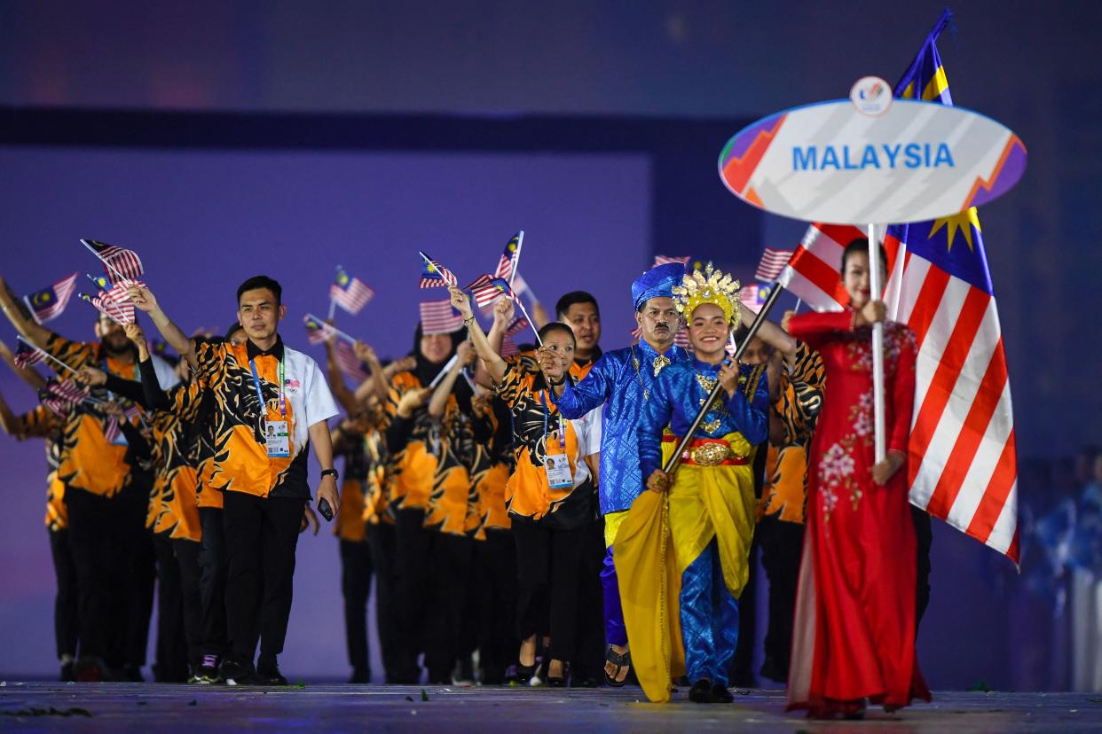 The Malaysia contingent enters the My Dinh National Stadium at the Hanoi SEA Games opening ceremony. 