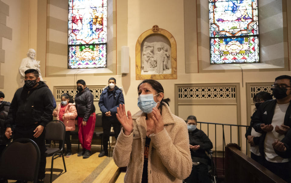 Congregants pray during a Spanish-language Easter service at St. Bartholomew Roman Catholic Church, Sunday, April 4, 2021, in New York. The parish has lost 80 members to COVID-19. (AP Photo/Mark Lennihan)