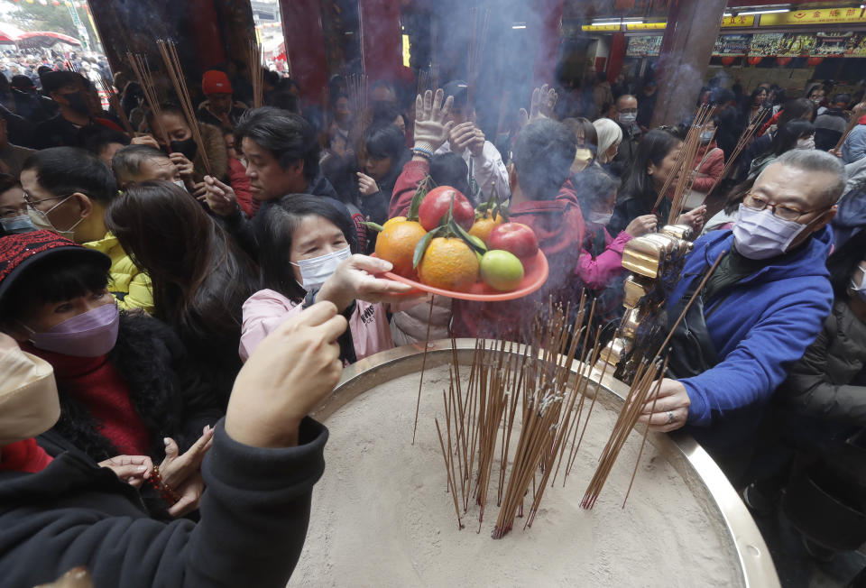 Worshippers go to pray at a temple on the first day of the Lunar New Year celebrations, in Taipei, Taiwan, Saturday, Feb. 10, 2024. Each year is named after one of the 12 signs of the Chinese zodiac in a repeating cycle, with this year being the Year of the Dragon. (AP Photo/Chiang Ying-ying)