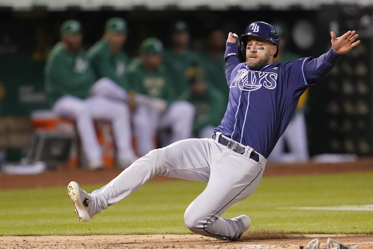 Tampa Bay Rays pitcher Phoenix Sanders, left, throws to first base