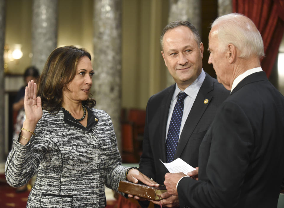 FILE - In this Tuesday, Jan. 3, 2017 file photo, Vice President Joe Biden administers the Senate oath of office to Sen. Kamala Harris, D-Calif., as her husband, Douglas Emhoff, holds the Bible during a a mock swearing in ceremony in the Old Senate Chamber on Capitol Hill in Washington as the 115th Congress begins. President-elect Biden and Vice President-elect Harris are set to take their oaths of office on Wednesday, Jan., 20, 2021, using Bibles that are laden with personal meaning, writing new chapters in a long-running American tradition – and one that appears nowhere in the law. (AP Photo/Kevin Wolf)