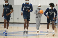 St. Peter's coach Shaheen Holloway, second from right, watches as his players warm up during NCAA college basketball practice, Tuesday, March 22, 2022, in Jersey City, N.J. (AP Photo/Seth Wenig)