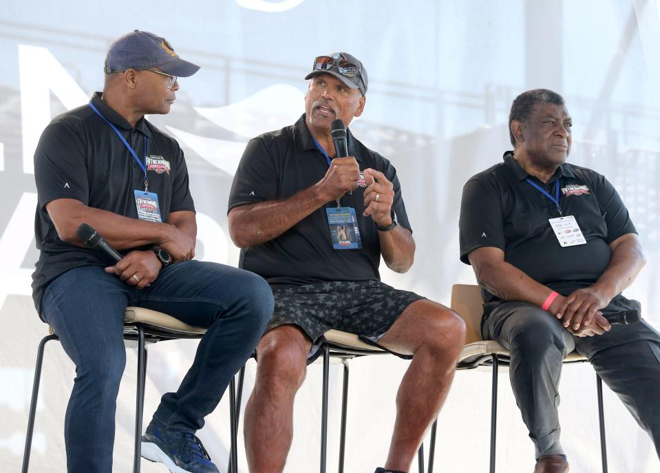 Pro Football Hall of Famer Anthony Munoz, center, speaks during the Hall of Fame Village Fatherhood Festival at Tom Benson Hall of Fame Stadium, Saturday, June 18, 2022. Looking on are Hall of Famers Mike Singletary, left, and Dave Robinson, right.