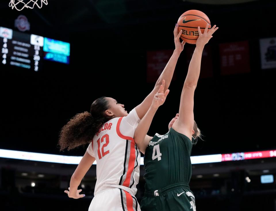 Jan. 14, 2024; Columbus, Ohio, USA; 
Ohio State Buckeyes guard Celeste Taylor (12) blocks a shot by Michigan State Spartans guard Theryn Hallock (4) during the second quarter of an NCAA Division I basketball game on Sunday at Value City Arena in Columbus.