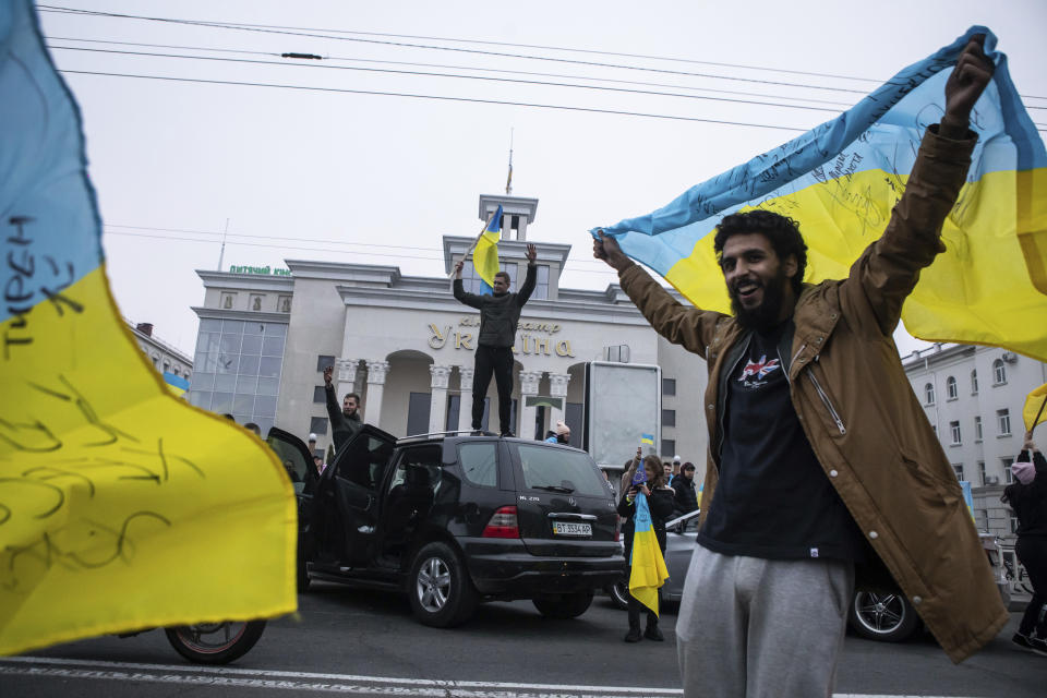 FILE - Ukrainians gather in downtown to celebrate the recapturing their city, Kherson, Ukraine, Saturday, Nov. 12, 2022. Amid the death and destruction war leaves in its wake, there are powerful dynamics and narratives: domination, besieged populations, occupation and their counterparts, resistance, freedom and liberation. Vast swaths of Western and Eastern Europe and the Soviet Union knew this well at various points of the 20th century. (AP Photo/Yevhenii Zavhorodnii, File)