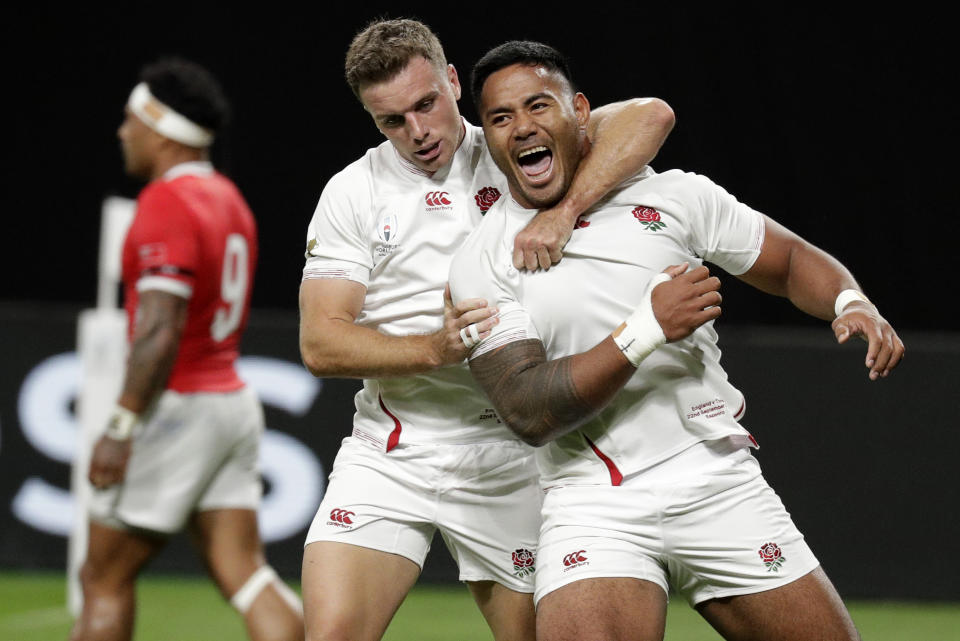 England's Manu Tuilagi, right, is congratulated by teammate George Ford after scoring his second try during the Rugby World Cup Pool C game at Sapporo Dome between England and Tonga in Sapporo, Japan, Sunday, Sept. 22, 2019. (AP Photo/Aaron Favila)