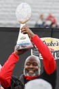 Maryland head coach Mike Locksley lifts the trophy after Maryland defeated North Carolina State 16-12 in the Duke's Mayo Bowl NCAA college football game in Charlotte, N.C., Friday, Dec. 30, 2022. (AP Photo/Nell Redmond)