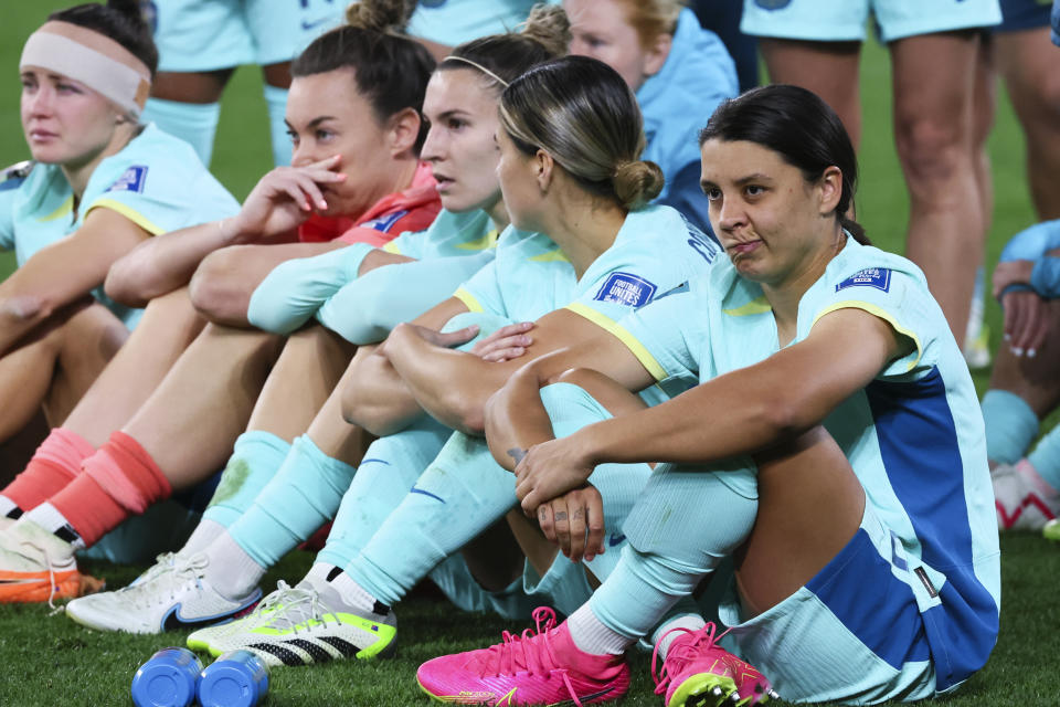Australia's Sam Kerr, right, sits with her teammates following their loss to Sweden in the Women's World Cup third place playoff soccer match in Brisbane, Australia, Saturday, Aug. 19, 2023. (AP Photo/Tertius Pickard)