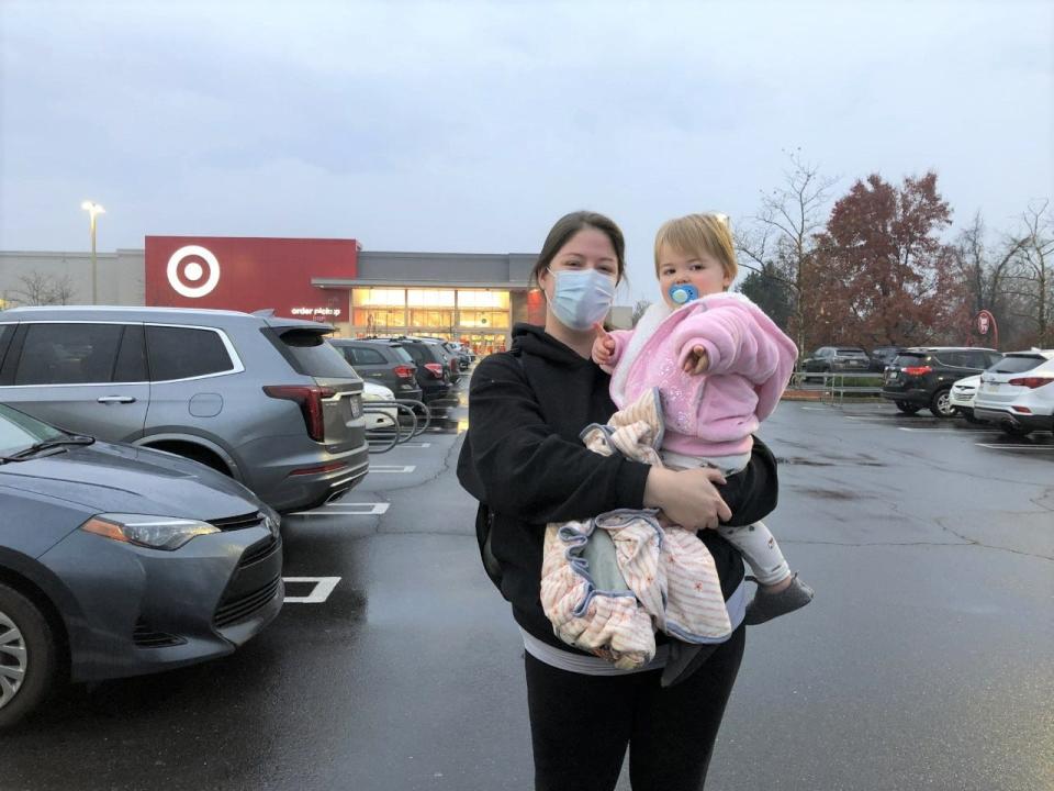 Stephanie Napoli of Lower Makefield takes her daughter, Audriana, 17 months, on her second Black Friday shopping excursion to the Target store in Middletown early Friday morning.