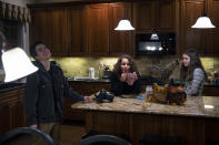 Leo Burchell, left, reacts during a conversation with his mother, Michele, and twin sister, Paige, at home in Pennsylvania on Wednesday, Nov. 16, 2022. To tell his parents, Leo shared a poem he had written about his transition. He worried it would be hard for them, as parents who had always identified as “girl parents” to three daughters. His mom, dad, older and twin sister were all supportive. (AP Photo/Joe Lamberti)